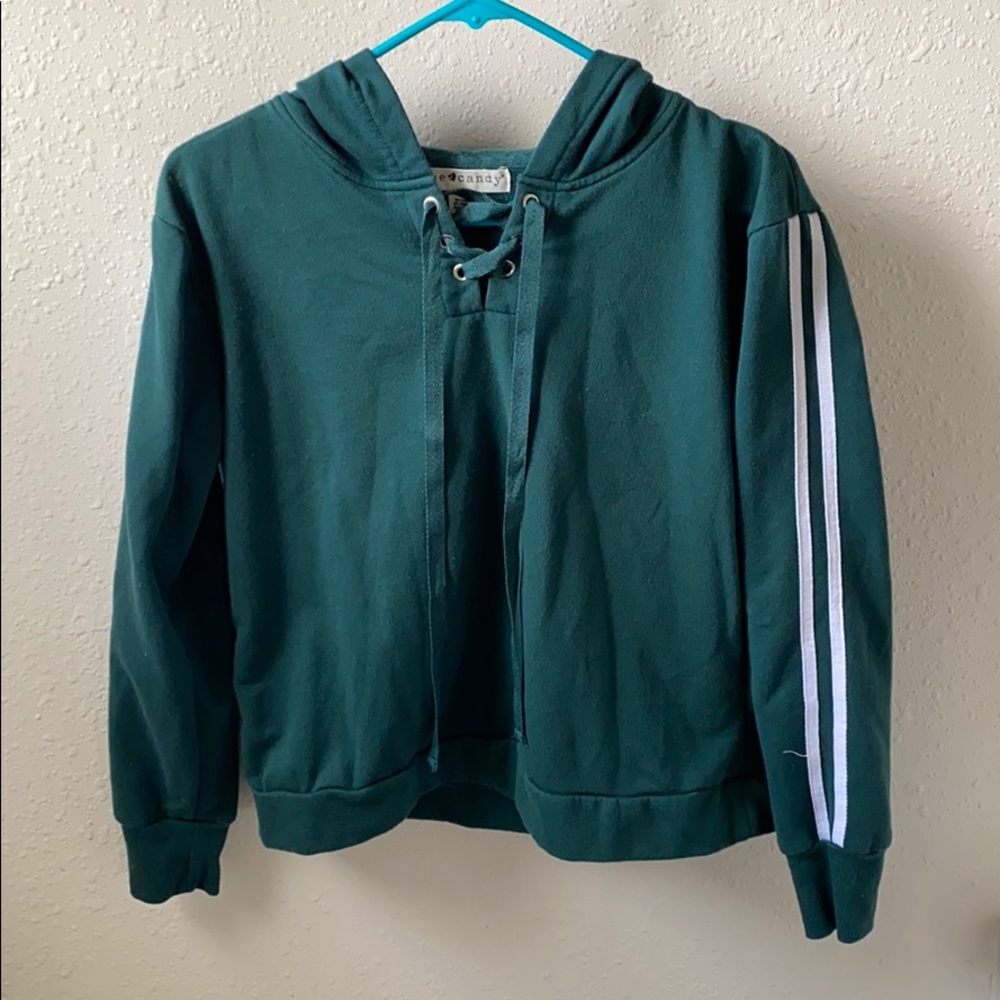 Green cropped sweatshirt with white stripes.